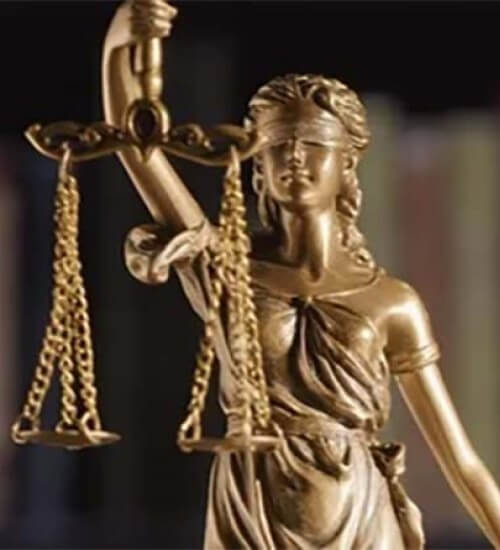 Bronze statue of Lady Justice holding scales and sword, symbolizing fairness and the law.