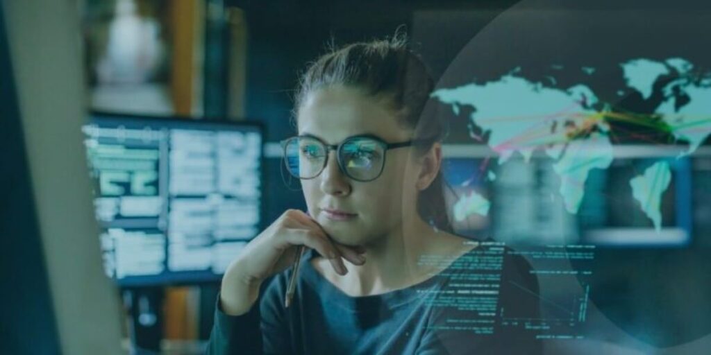 Woman wearing glasses reviewing cybersecurity data with a digital map overlay, focusing on OSINT technology.