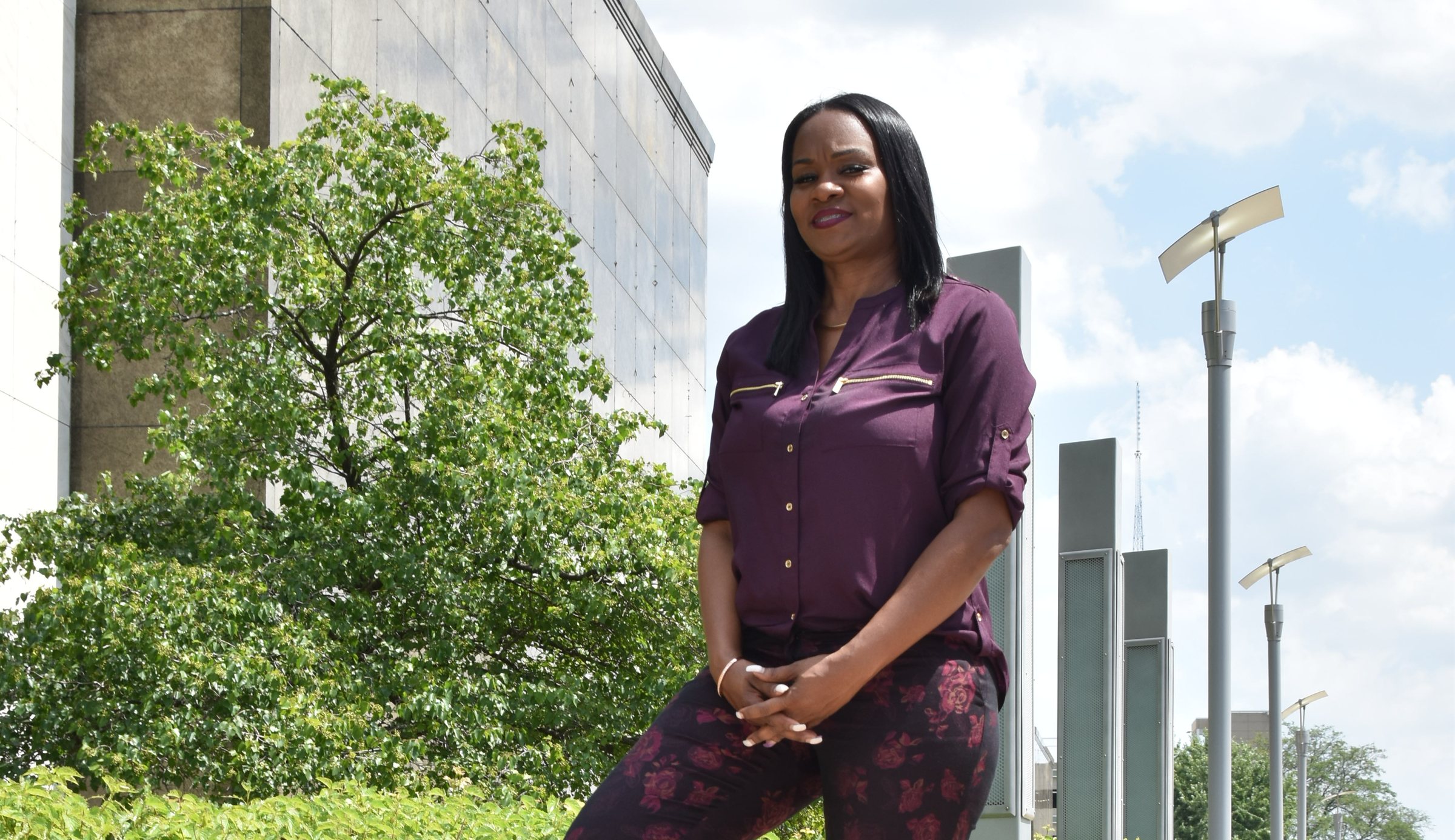 Yada Phillips, Founder and Chief Investigator, outside a downtown building