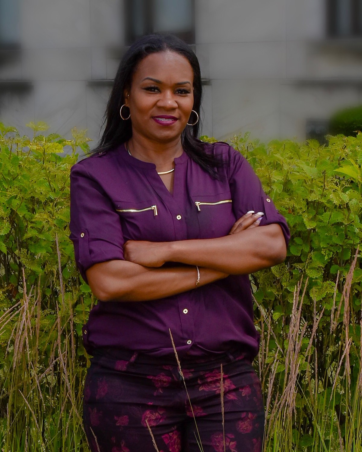 Yada Phillips standing with arms crossed outside a stone building
